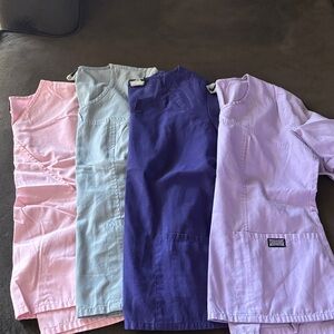Set of Four Scrub Tops in Pink, Light Grey , Dark Purple , and Lavender